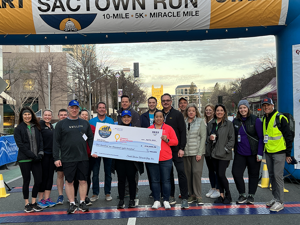 Credit Union SACTOWN Run organizers proudly display this year’s check for $210,800 at the race’s starting line on Sunday April 2nd near the California State Capitol in Sacramento, CA — with donations going to help kids across 11 Children’s Miracle Network Hospitals (CMN) in California and Nevada.