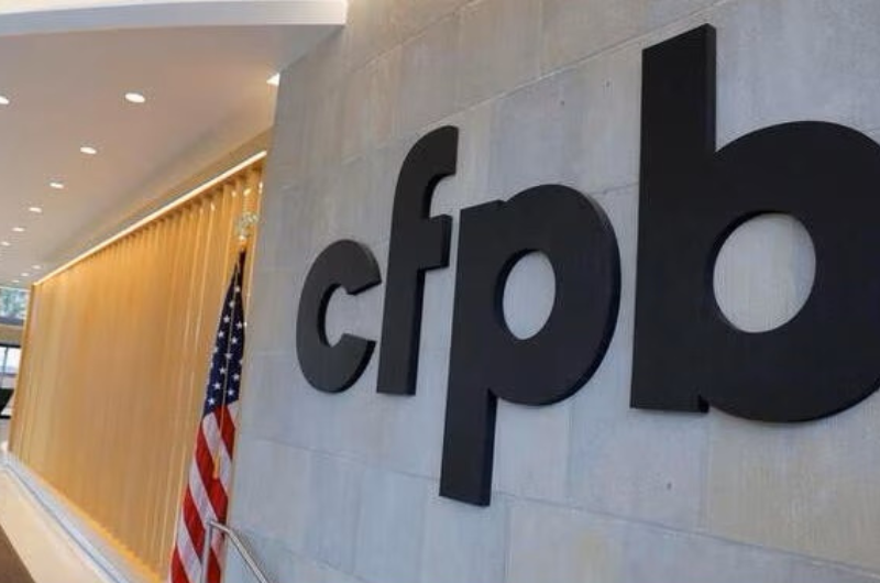 Consumer Financial Protection Bureau sign on wall.