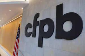 Consumer Financial Protection Bureau sign on wall.