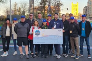 Members of the Credit Union SACTOWN Run Committee proudly display this year’s donation check for $216,500 during Sunday morning at the starting line in downtown Sacramento. Donations will help kids across 11 Children’s Miracle Network Hospitals (CMN) in California and Nevada.